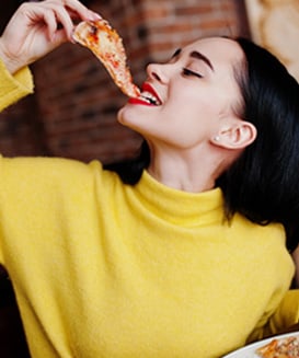 Woman eating pizza